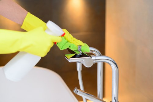 Professional carpets cleaner in Bow deep cleaning a living room carpet